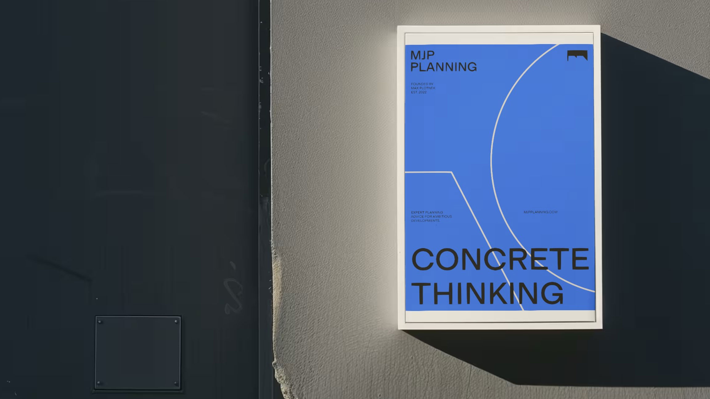 A blue poster on a concrete wall saying 'Concrete Thinking"