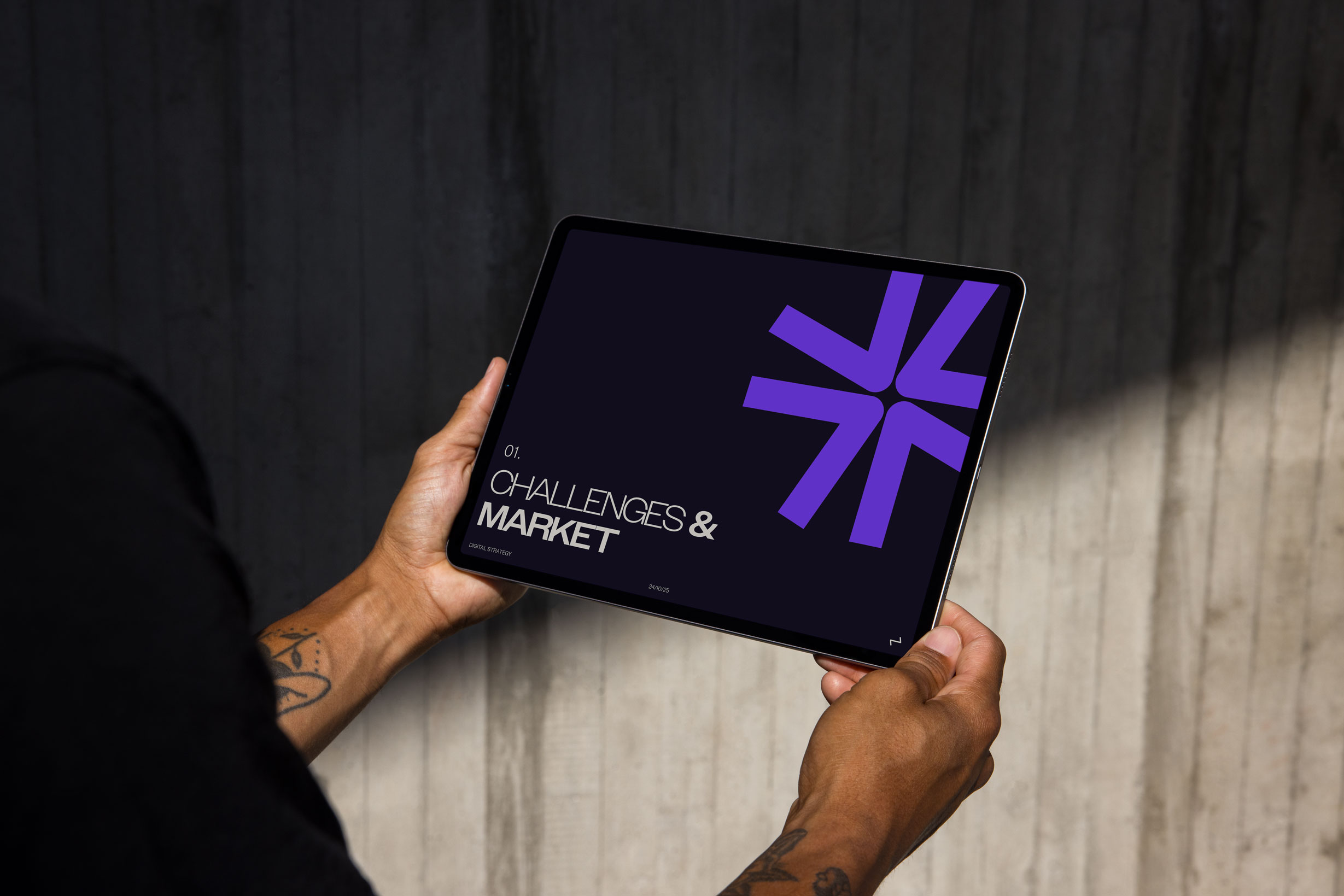 Someone holding an ipad with 'Challenges and Marketing' as a title on the screen