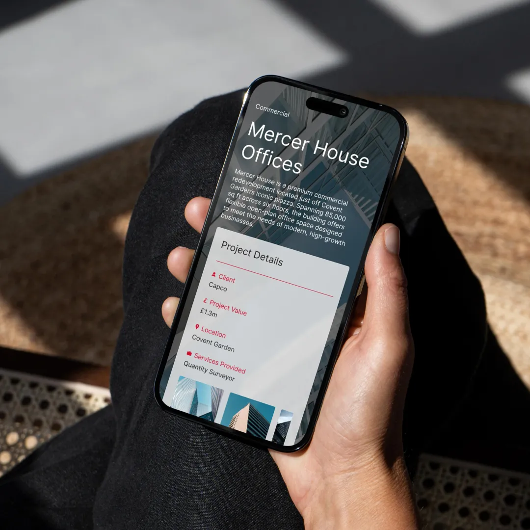 A hand holding a mobile phone and viewing the CSA website